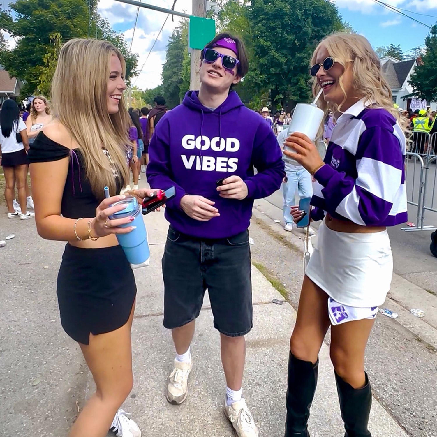 Students on campus, one in a Good Vibes hoodie
