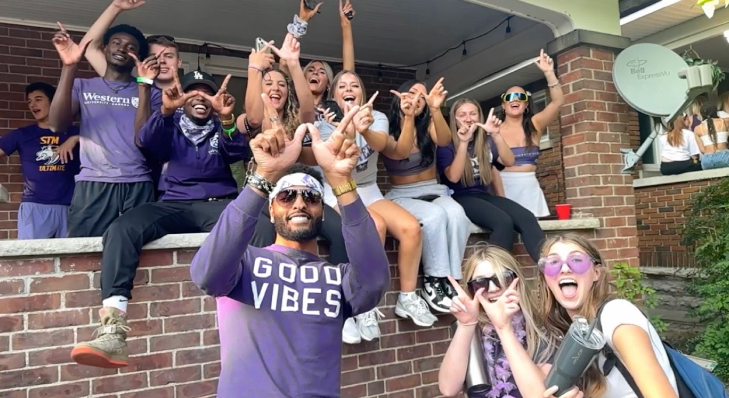 A porch full of students in Good Vibes and Western merch